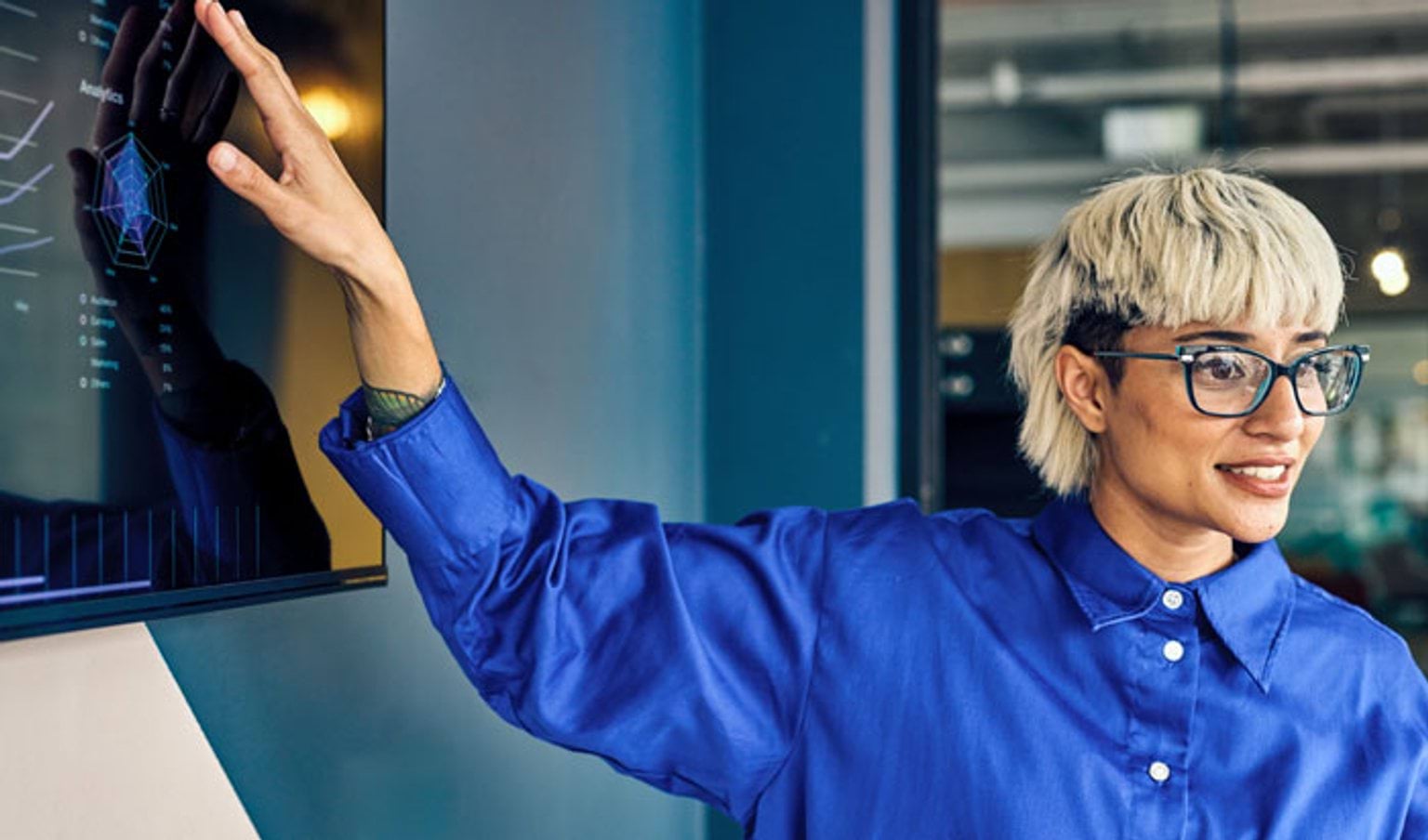 A person in a blue shirt giving a presentation about data and analytics