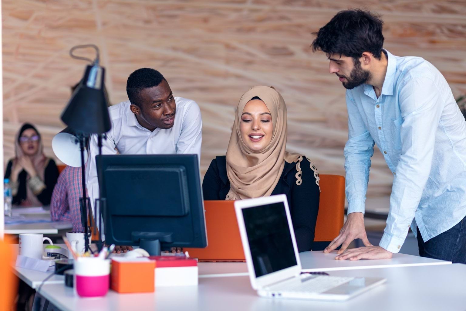 Group of people looking at a computer